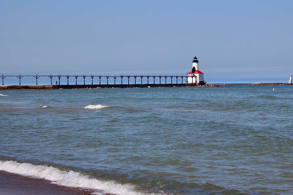 Strong and sometimes dangerous currents can form near structures along the Great Lakes, like around this Lake Michigan lighthouse along the shores of Michigan City, Ind. (Bridge photo by Jim Malewitz)