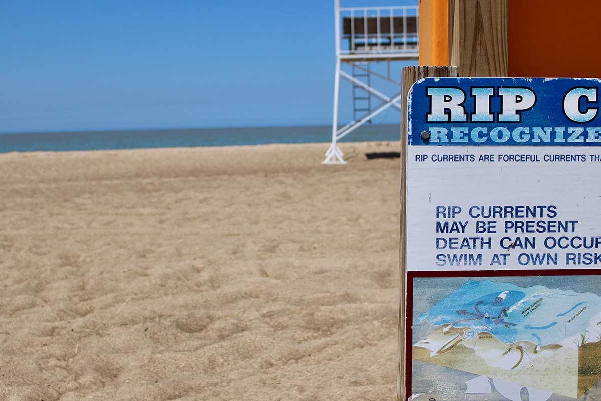 A sign warning of rip currents at New Buffalo Lakefront Park and Beach. (Bridge photo by Jim Malewitz)