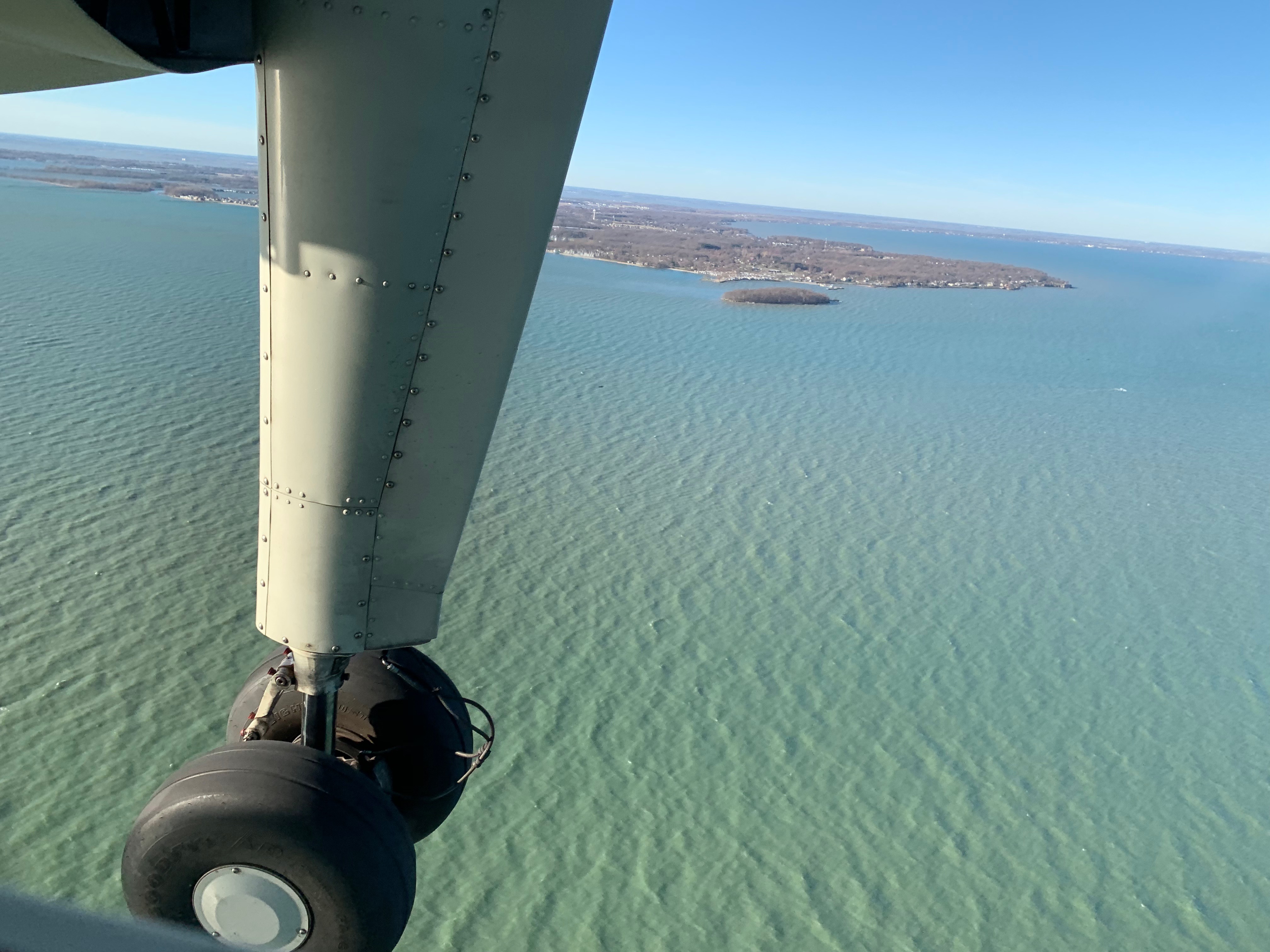 View of lake through wing of plane