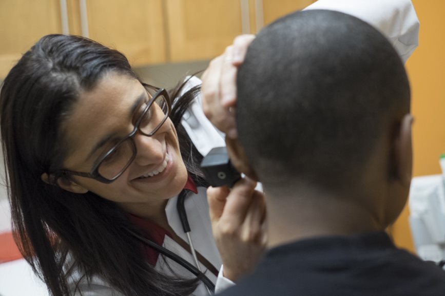 Dr. Mona Hanna-Attisha checking the temperature of a child